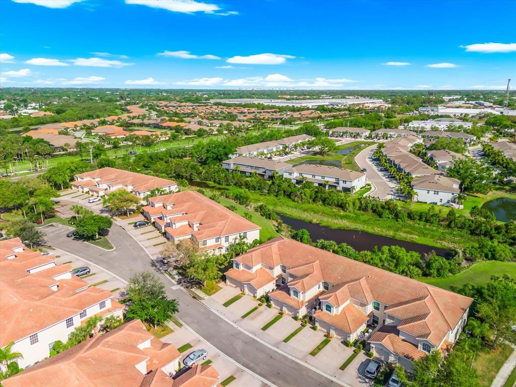 4500 Streamside Court, Unit 1408 Sarasota, FL 34238 - Photo 42 of 73 an aerial view of residential houses with outdoor space and ocean view
