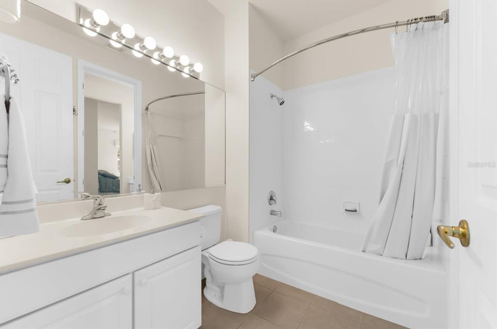 4500 Streamside Court, Unit 1408 Sarasota, FL 34238 - Photo 46 of 73 a bathroom with a double vanity sink toilet and shower