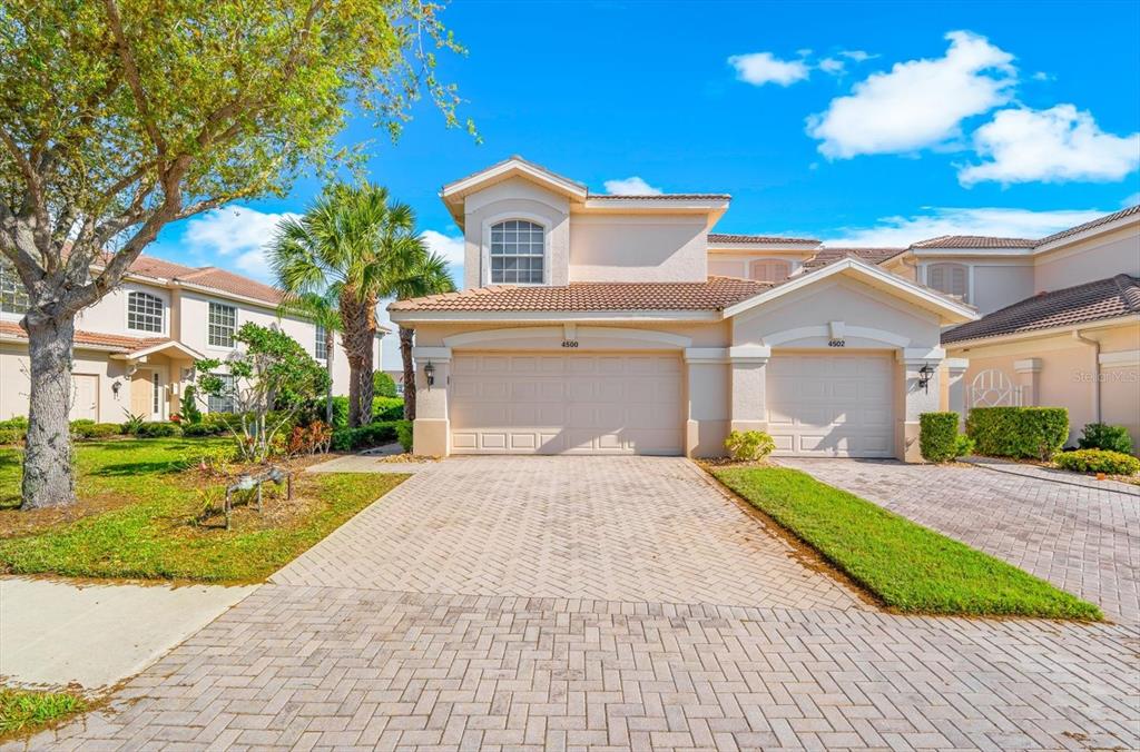 4500 Streamside Court, Unit 1408 Sarasota, FL 34238 - Photo 5 of 73 a front view of a house with a yard and garage