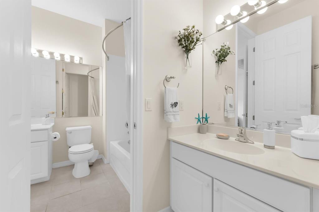 4500 Streamside Court, Unit 1408 Sarasota, FL 34238 - Photo 51 of 73 a bathroom with a sink a toilet and a mirror