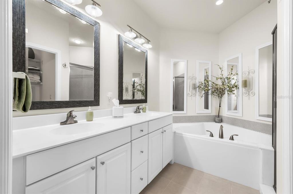 4500 Streamside Court, Unit 1408 Sarasota, FL 34238 - Photo 55 of 73 a bathroom with a bathtub sink double and mirror