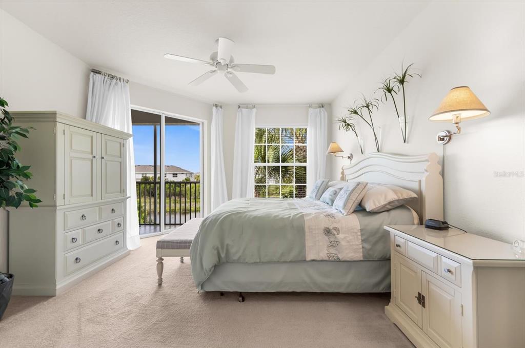 4500 Streamside Court, Unit 1408 Sarasota, FL 34238 - Photo 58 of 73 a bedroom with a bed and a chandelier