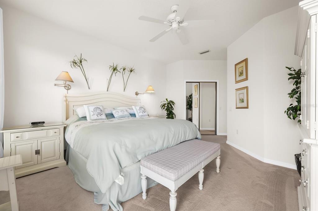 4500 Streamside Court, Unit 1408 Sarasota, FL 34238 - Photo 61 of 73 a bedroom with a bed and a chandelier
