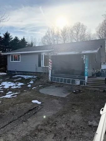 a view of a house with a yard and a car parked in it