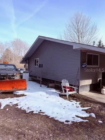 a view of a patio with table and chairs with wooden floor and fence