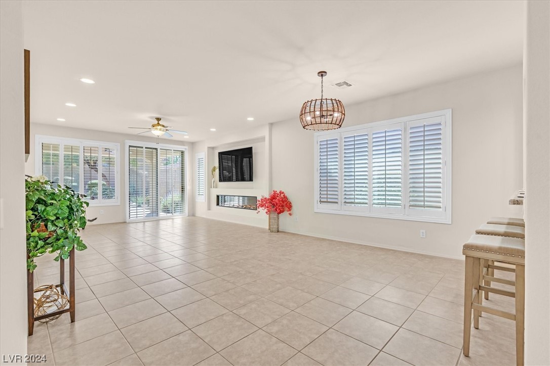 9 Chatmoss Road Henderson, NV 89052 - Photo 5 of 45 Great room with electric fireplace and shutters