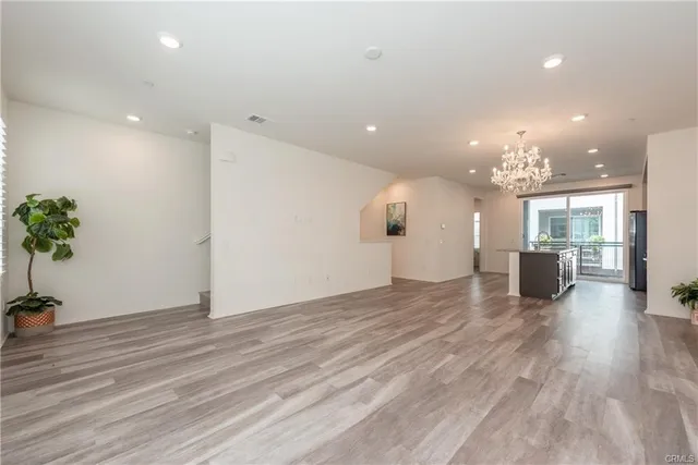 a view of a big room with wooden floor and a large window