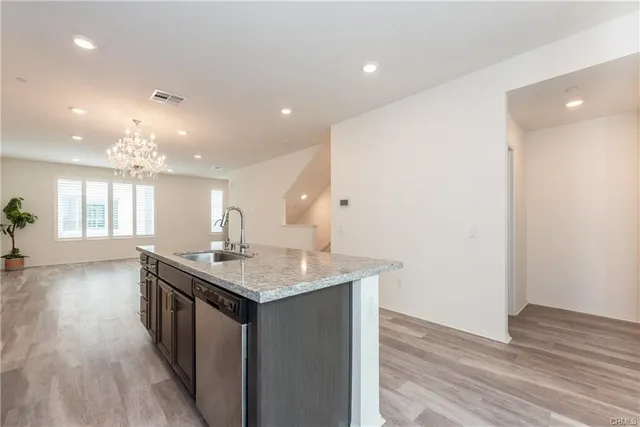a kitchen with a sink and a stove top oven