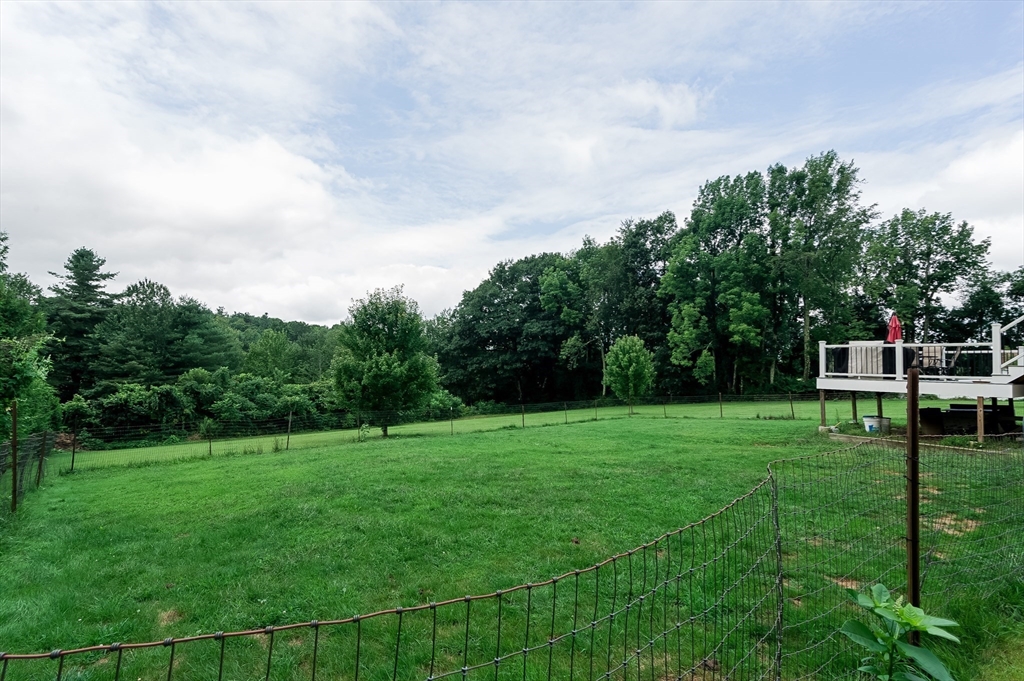 47 Glenwood Road Rutland, MA 01543 - Photo 32 of 35 a view of a grassy field with trees in the background