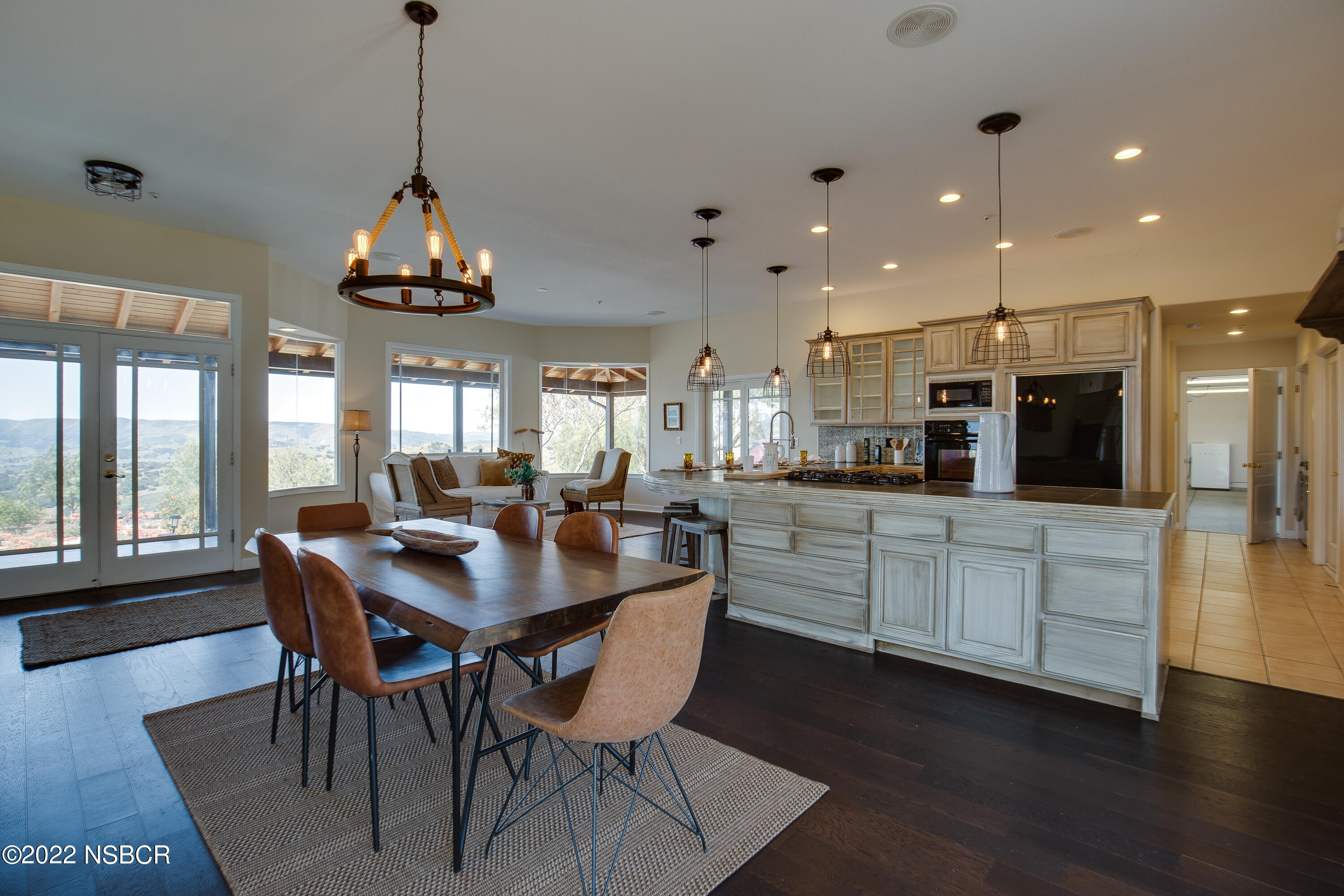 1833 Cougar Ridge Road Buellton, CA 93427 - Photo 14 of 46 a kitchen with stainless steel appliances kitchen island granite countertop a table and chairs in it