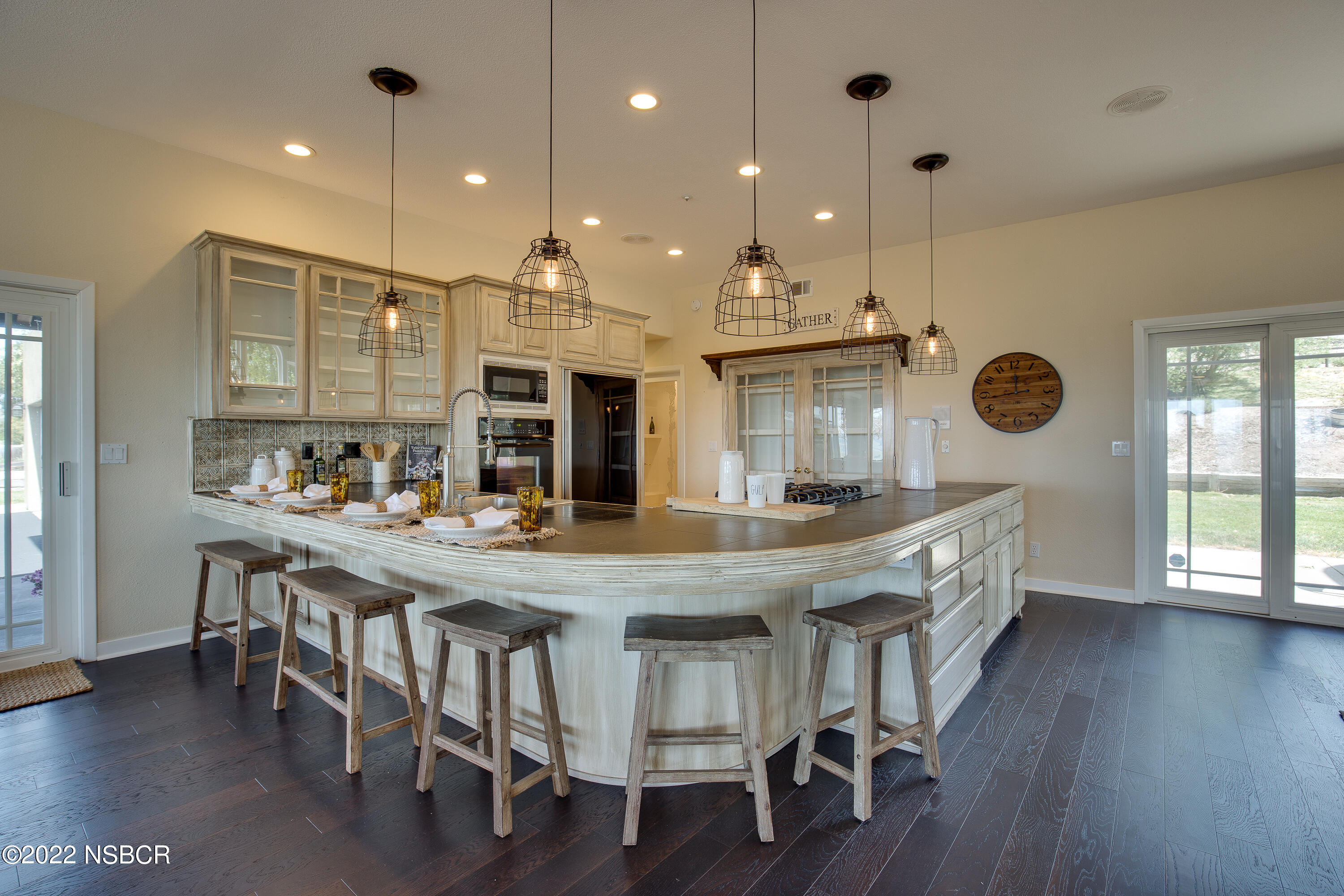 1833 Cougar Ridge Road Buellton, CA 93427 - Photo 15 of 46 a kitchen with stainless steel appliances granite countertop a dining table chairs and wooden floor