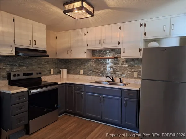 a kitchen with stainless steel appliances granite countertop a sink and cabinets