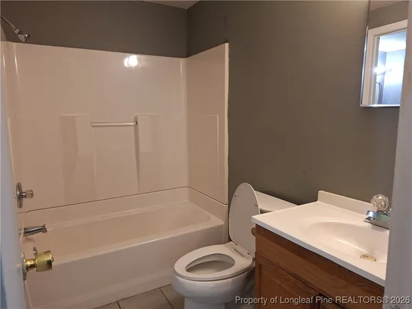 a white toilet sitting next to a bathroom sink