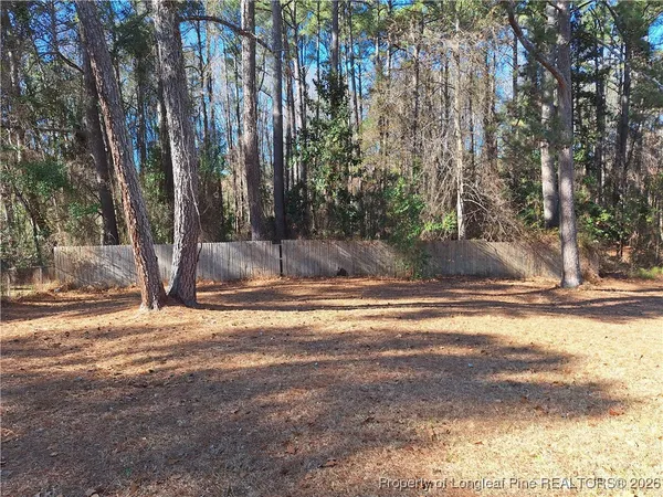 a backyard of a house with large trees