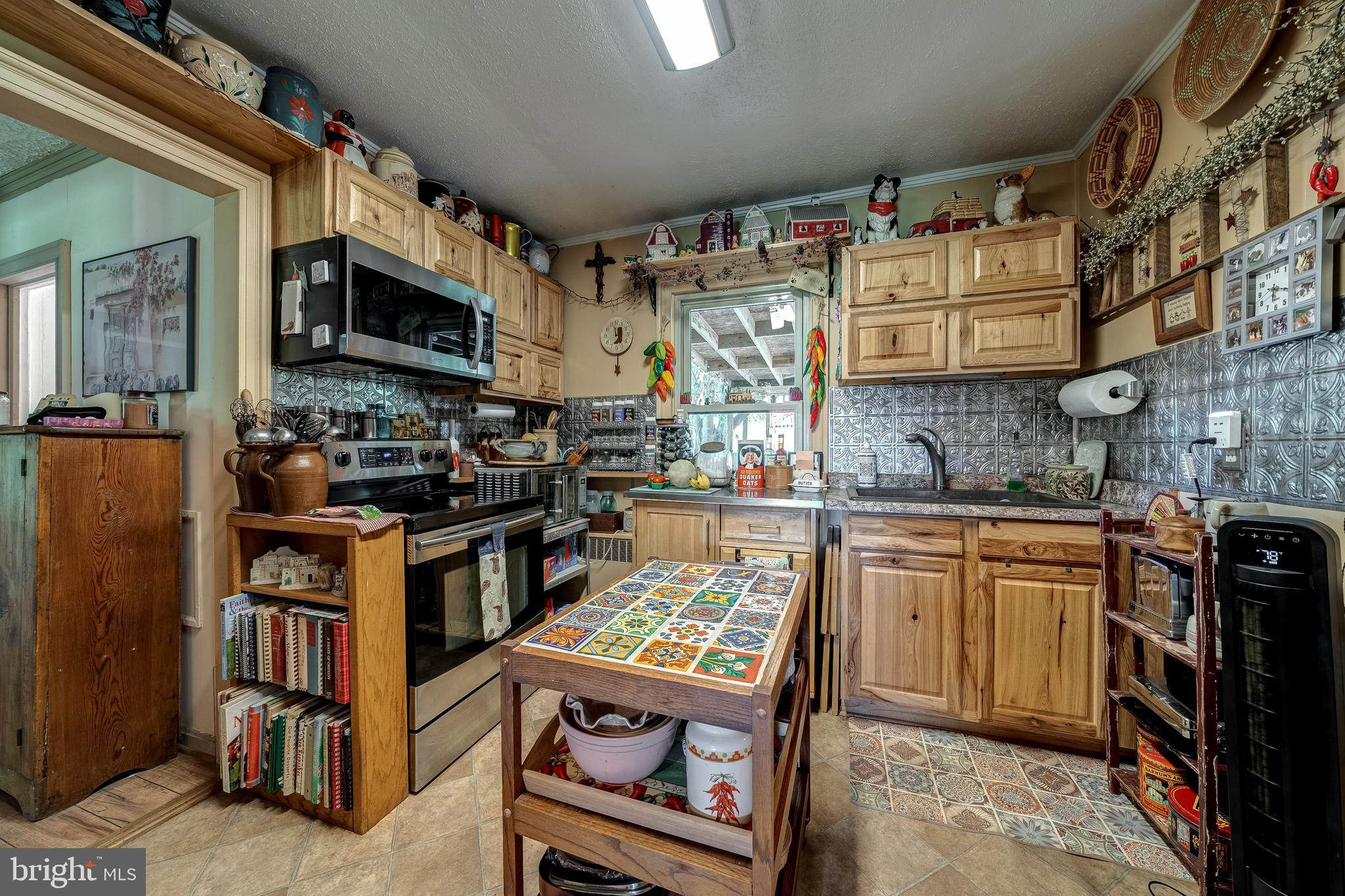 3637 Millwood Road Boyce, VA 22620 - Photo 42 of 62 a kitchen with stainless steel appliances granite countertop a stove top oven a sink and a microwave