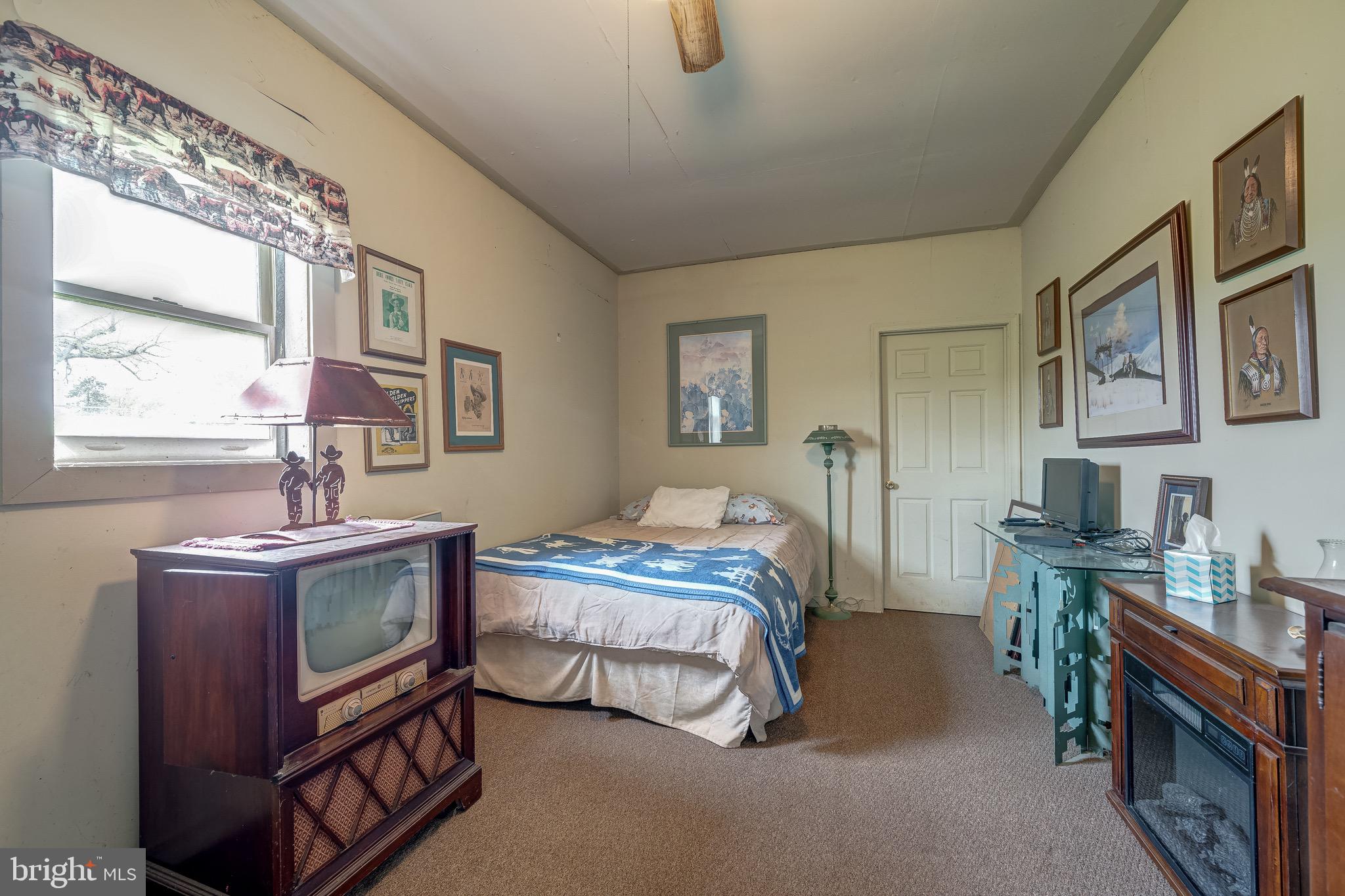 3637 Millwood Road Boyce, VA 22620 - Photo 58 of 62 a bedroom with a bed next to a window with the dresser