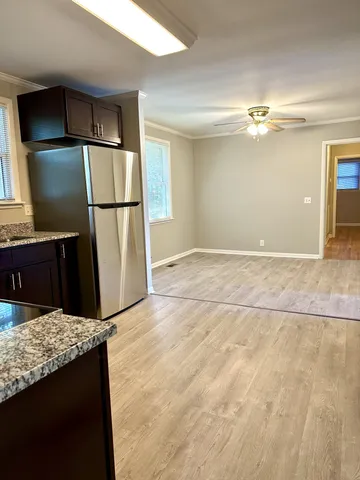 a view of kitchen with refrigerator and cabinet