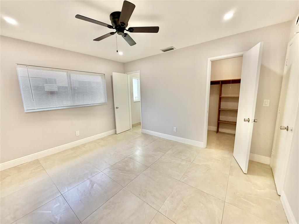 2210 Northeast 54th Street, Unit W Fort Lauderdale, FL 33308 - Photo 12 of 21 a view of an empty room with a ceiling fan