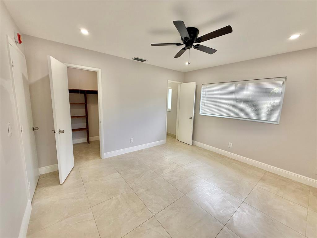 2210 Northeast 54th Street, Unit W Fort Lauderdale, FL 33308 - Photo 15 of 21 an empty room with closet and windows