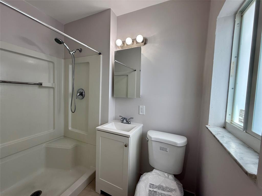 2210 Northeast 54th Street, Unit W Fort Lauderdale, FL 33308 - Photo 16 of 21 a bathroom with a sink toilet and shower