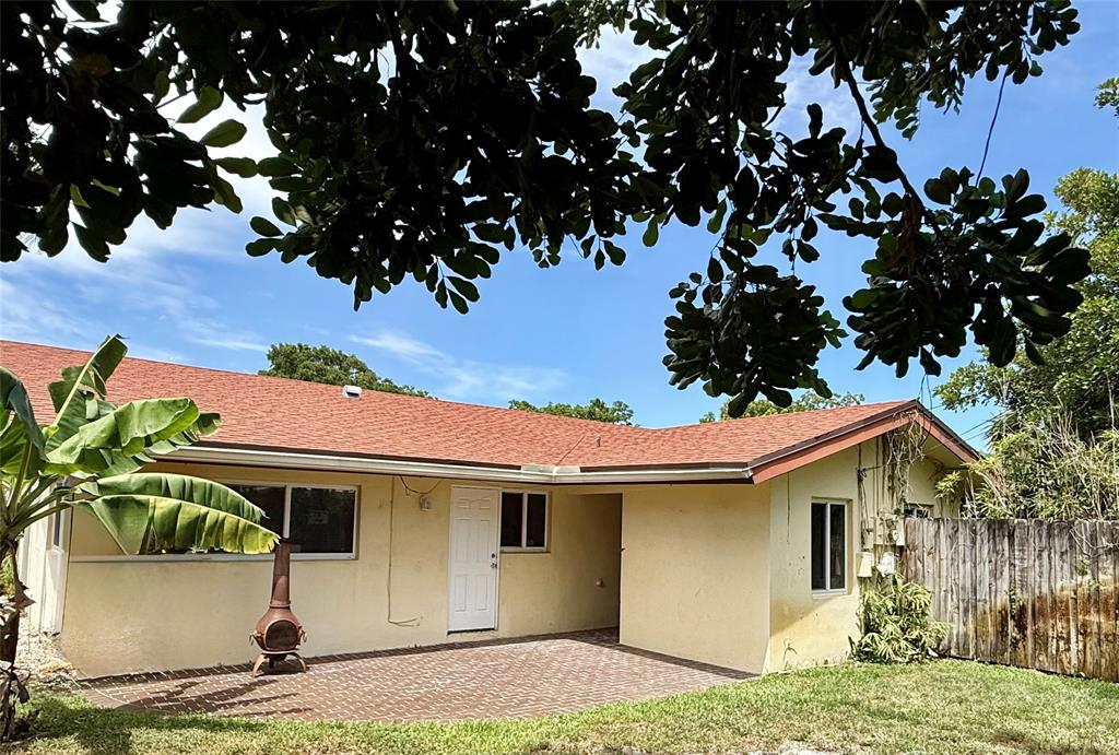 2210 Northeast 54th Street, Unit W Fort Lauderdale, FL 33308 - Photo 18 of 21 a front view of a house with garden