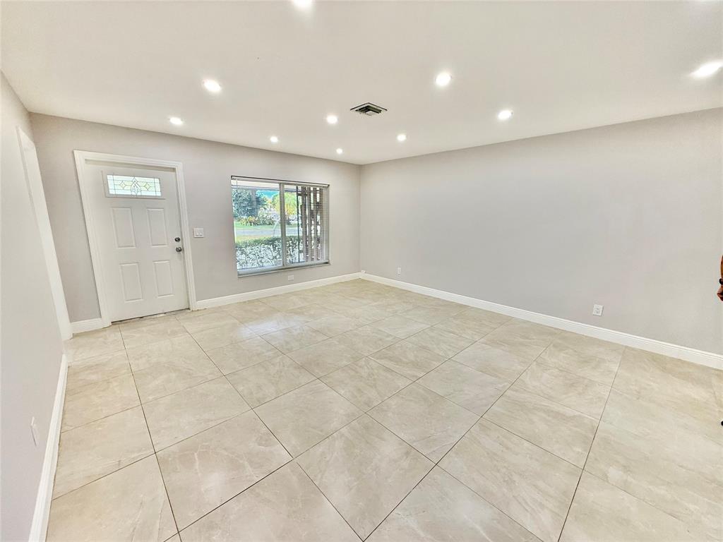2210 Northeast 54th Street, Unit W Fort Lauderdale, FL 33308 - Photo 2 of 21 an empty room with windows and closet