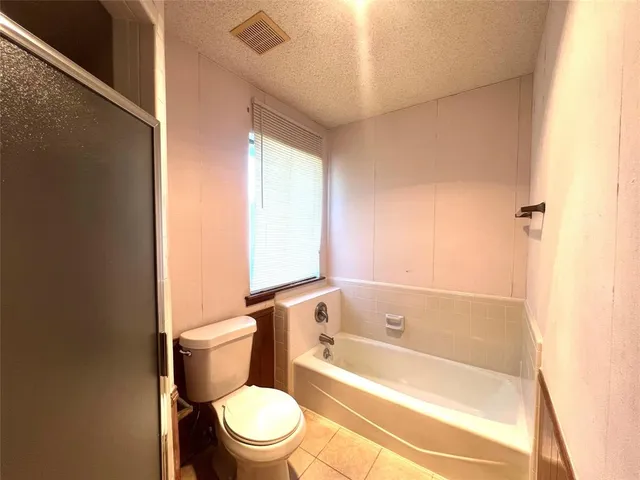 a bathroom with a bathtub and toilet