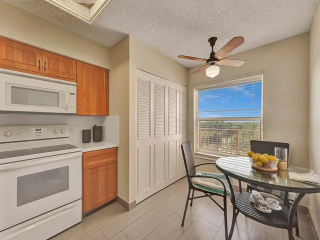 a kitchen with a stove a table and chairs