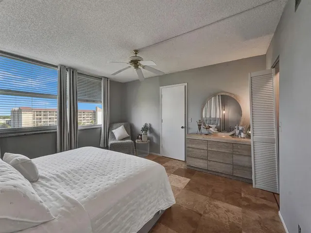 a bedroom with a bed and dresser with mirror