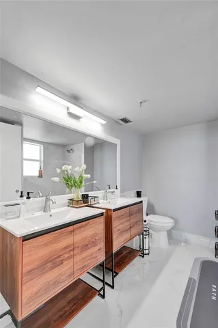 a room with sink washer and piano