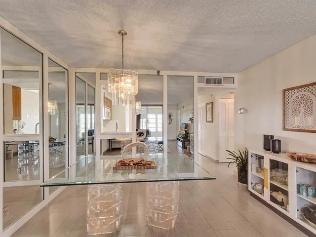 a living room with lots of furniture and a chandelier