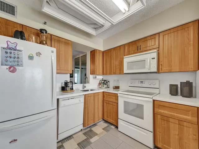 a kitchen with a sink a stove and cabinets