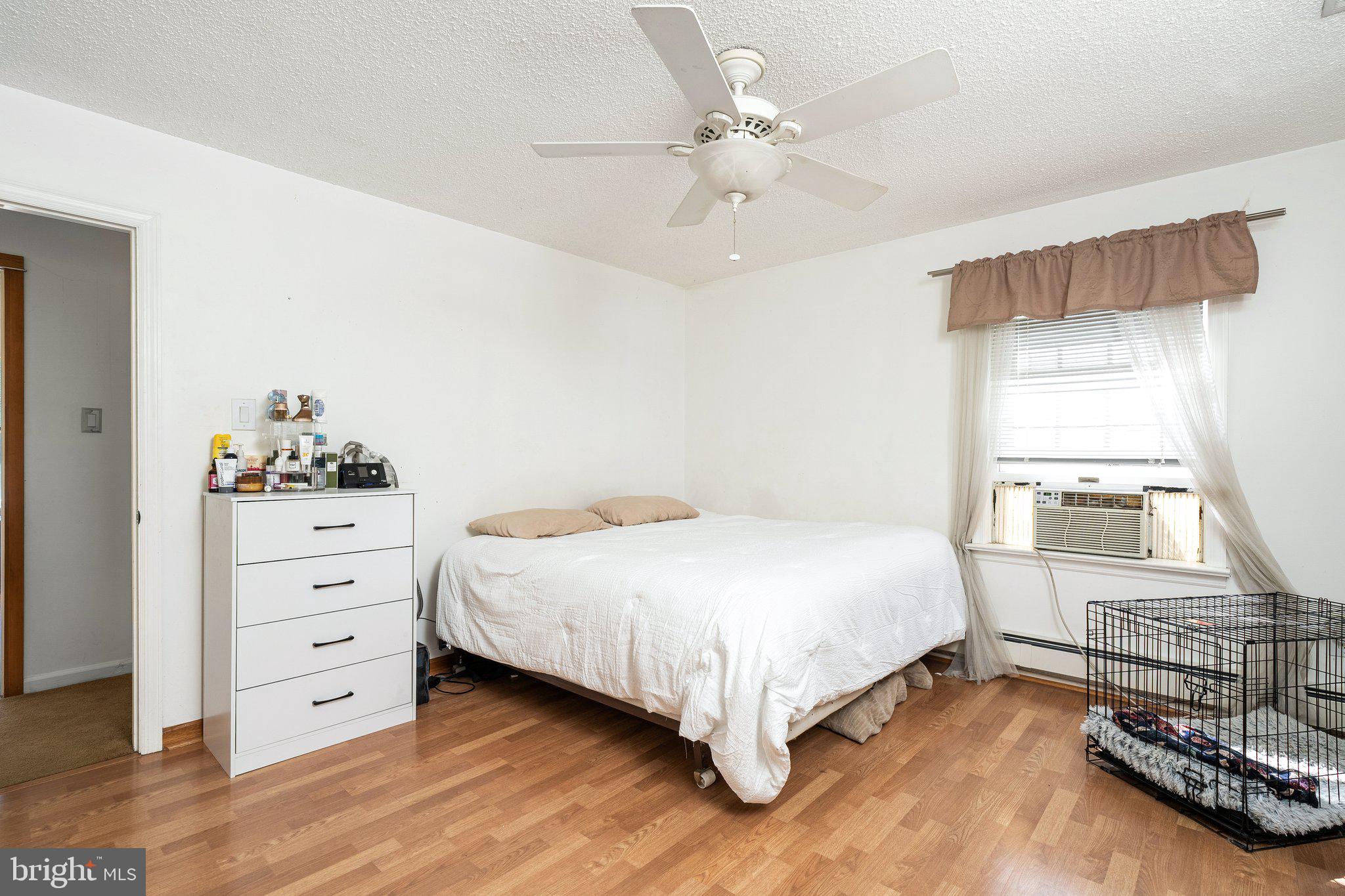 87 Bordentown Chesterfield Road Chesterfield, NJ 08515 - Photo 15 of 49 a bedroom with a bed and a chandelier