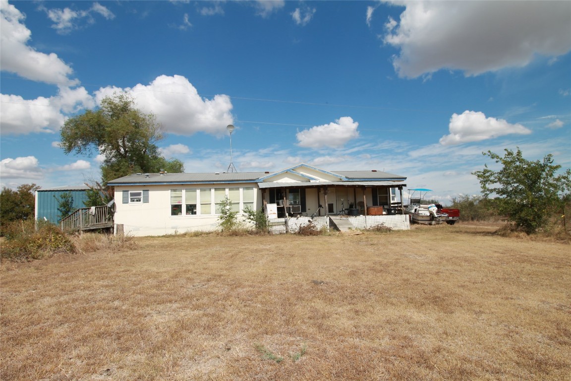 1875 County Road 466 Elgin, TX 78621 - Photo 4 of 11 a view of a house with a yard and sitting area