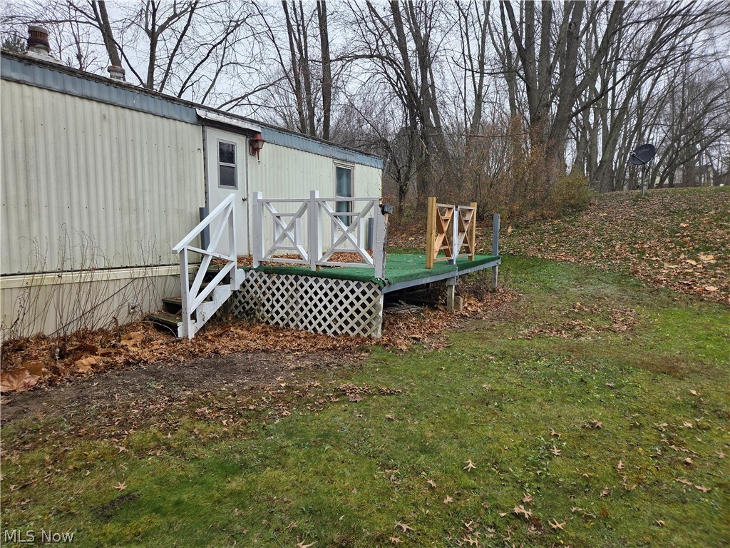 7443 Spillway Road, Unit 58 Lisbon, OH 44432 - Photo 4 of 15 View of green lawn featuring a wooden deck