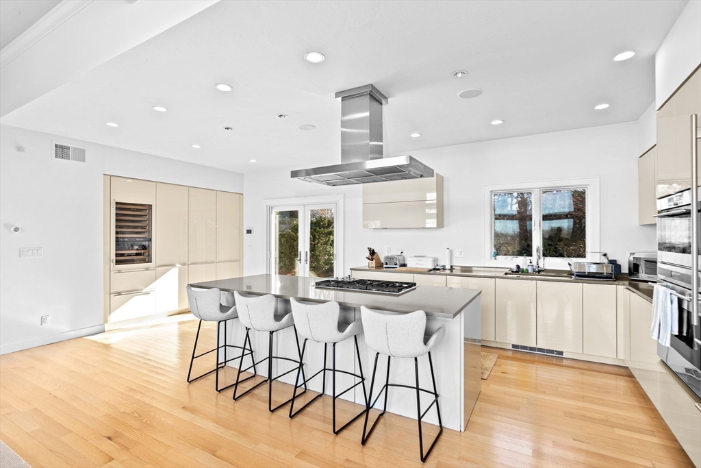 68 Nichols Road Cohasset, MA 02025 - Photo 12 of 41 a kitchen with stainless steel appliances a table and chairs in it