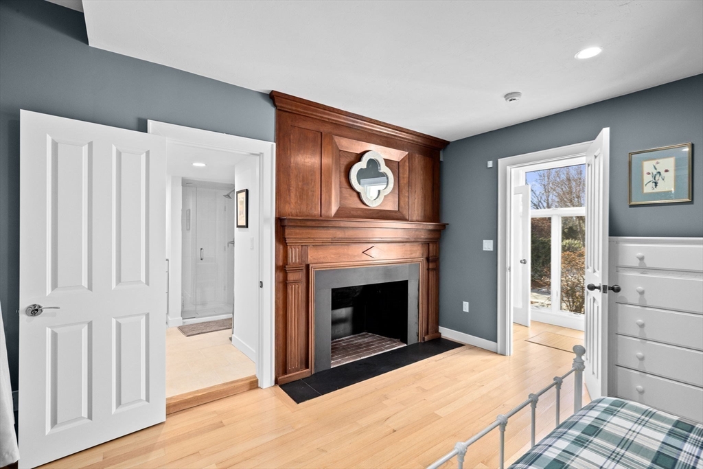 68 Nichols Road Cohasset, MA 02025 - Photo 24 of 41 a bedroom with furniture and a fireplace