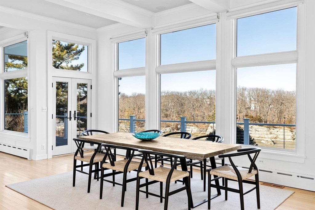 68 Nichols Road Cohasset, MA 02025 - Photo 8 of 41 a view of a dining room with furniture large windows and wooden floor