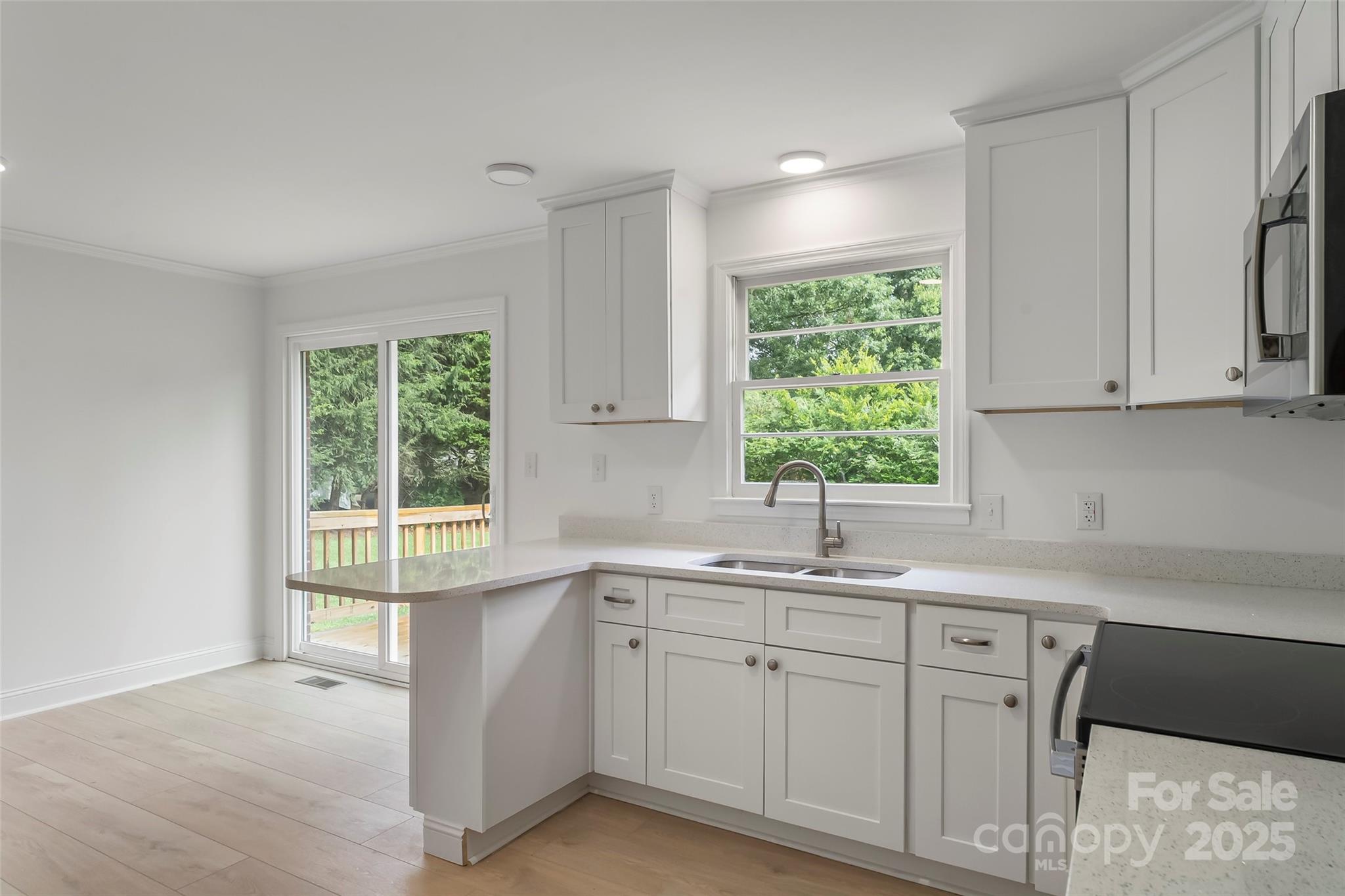 4146 Old State Road Newton, NC 28658 - Photo 2 of 26 a kitchen with a sink window and cabinets