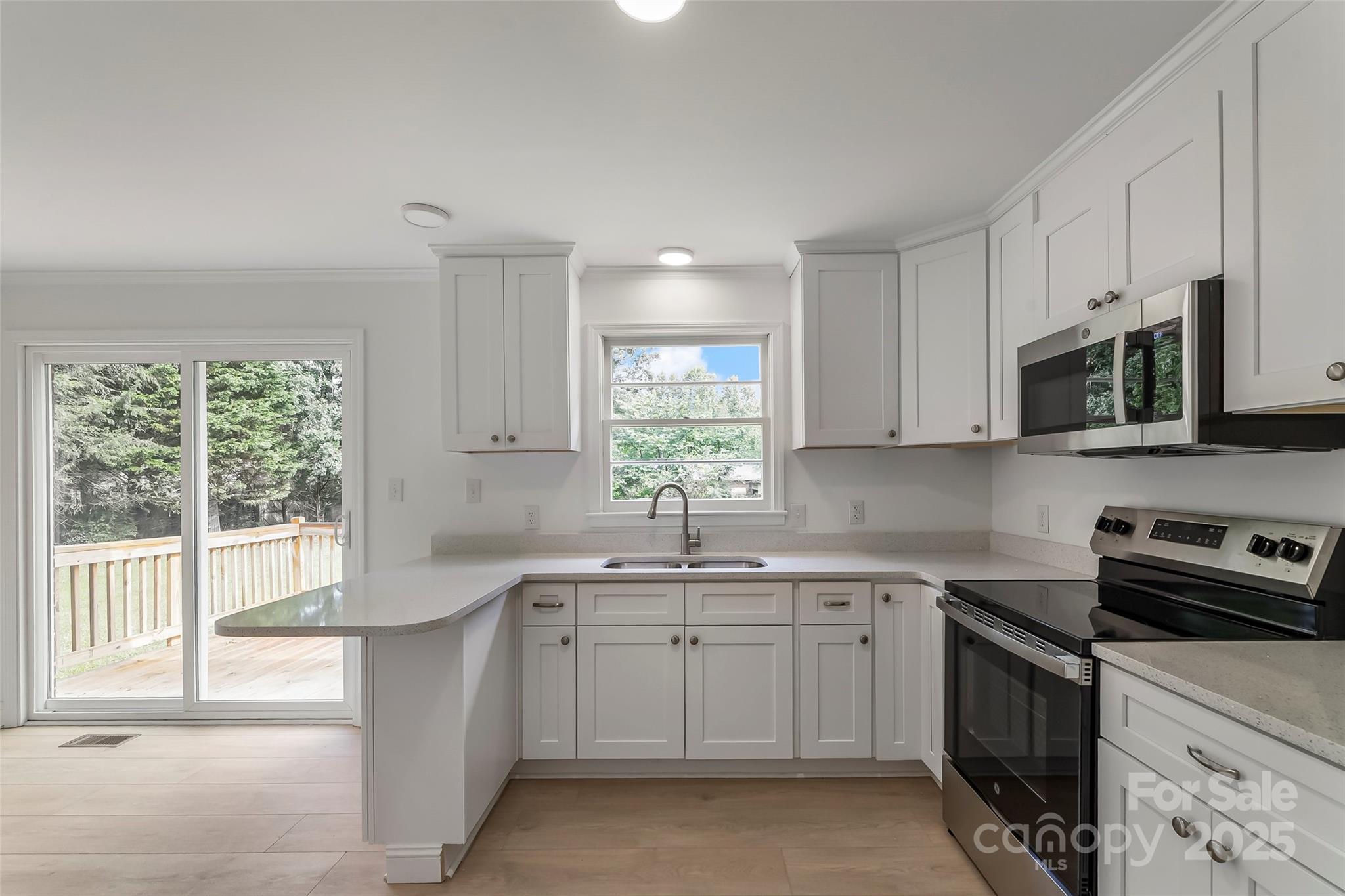 4146 Old State Road Newton, NC 28658 - Photo 3 of 26 a kitchen that has a sink and a stove in it