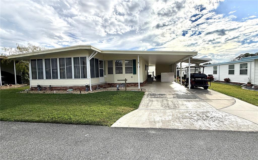 a front view of a house with a yard table and chairs