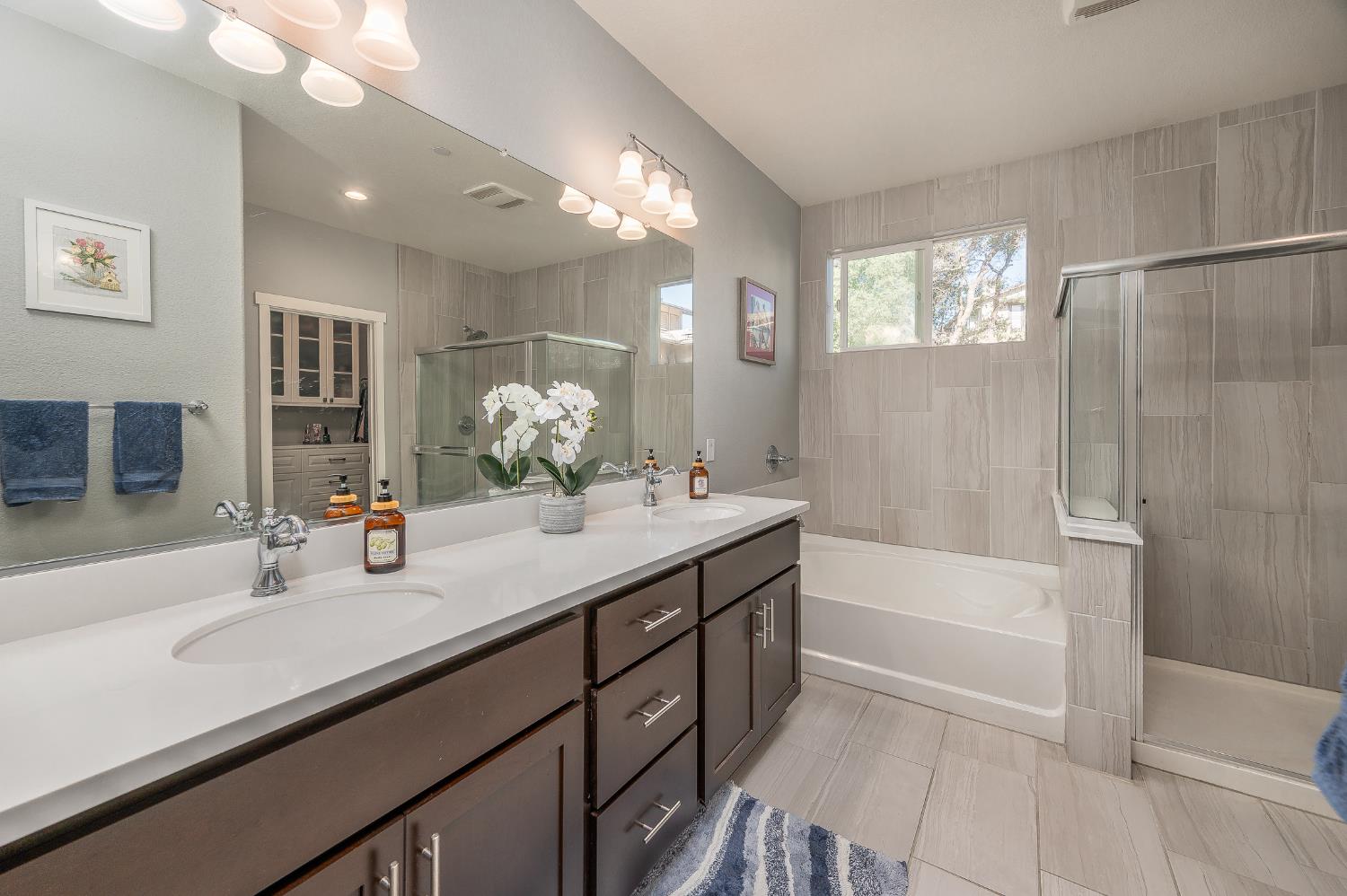 401 McCauley Ranch Road Angels Camp, CA 95222 - Photo 26 of 57 a bathroom with a tub a sink double vanity and a mirror