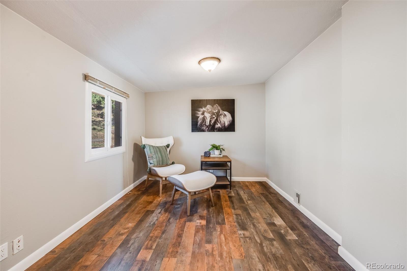 8644 Doubleheader Ranch Road Morrison, CO 80465 - Photo 20 of 36 a living room with a rug