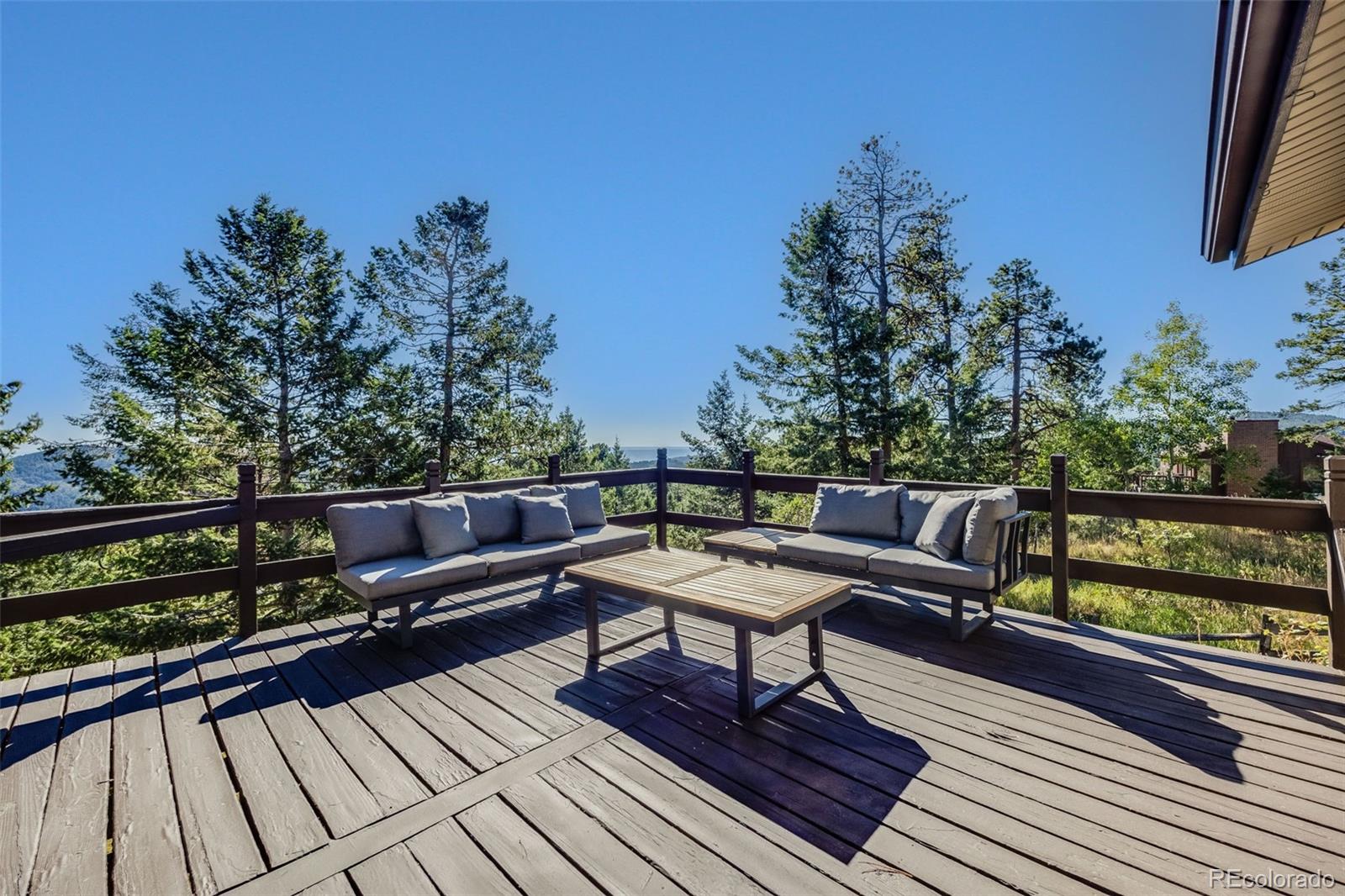 8644 Doubleheader Ranch Road Morrison, CO 80465 - Photo 23 of 36 a balcony with wooden floor and outdoor seating