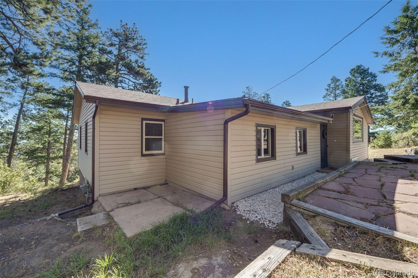 8644 Doubleheader Ranch Road Morrison, CO 80465 - Photo 28 of 36 a view of a house with a yard