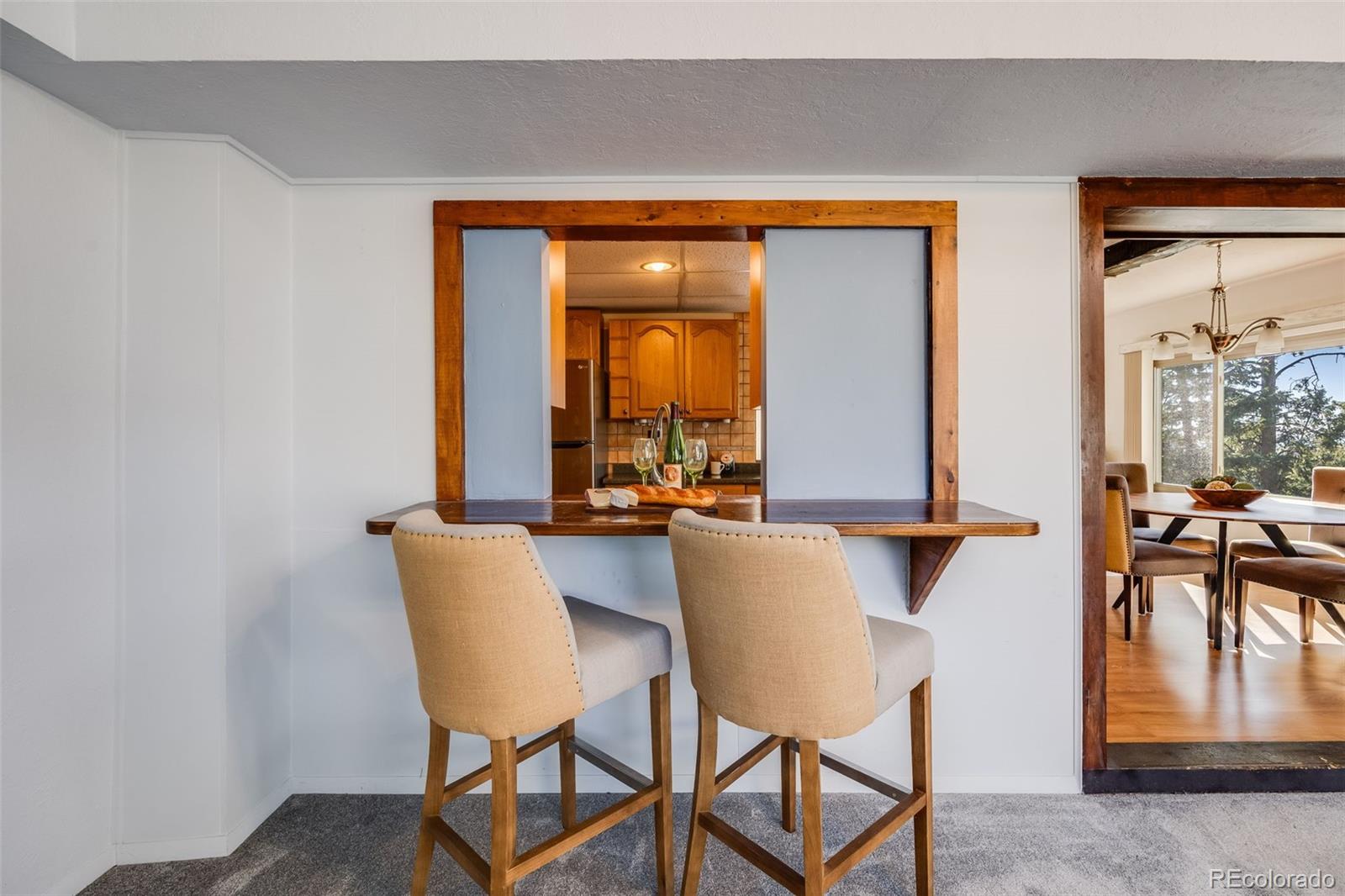 8644 Doubleheader Ranch Road Morrison, CO 80465 - Photo 5 of 36 a view of a dining room with furniture and a window