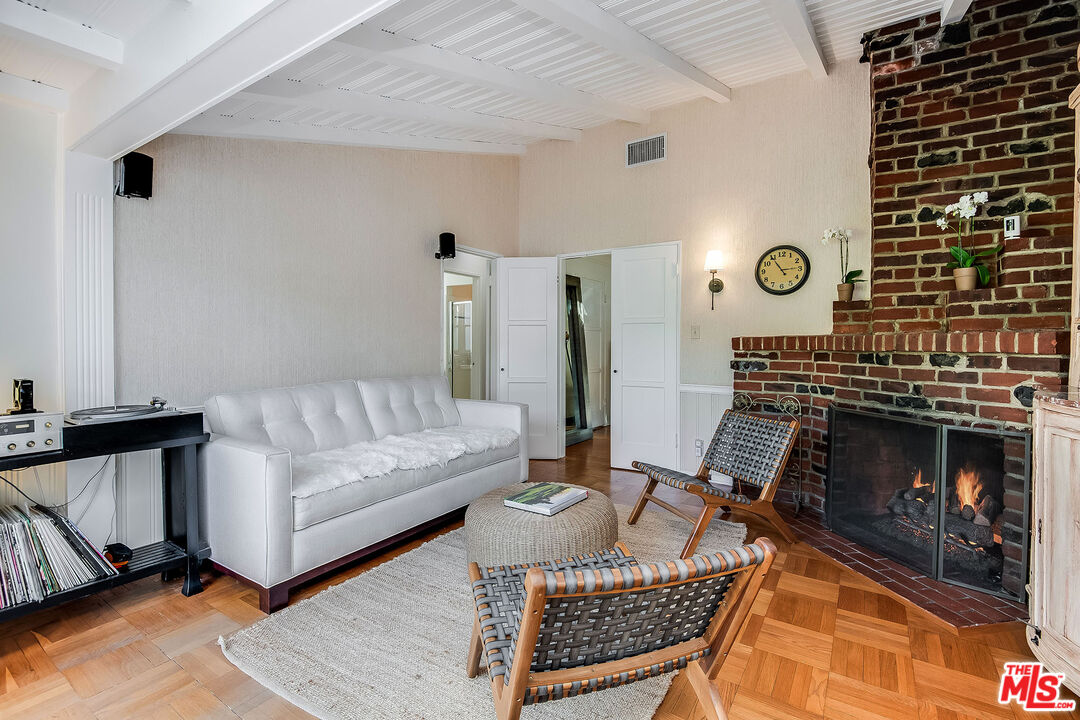 4227 Warner Boulevard Burbank, CA 91505 - Photo 22 of 41 a living room with furniture a rug and a fireplace