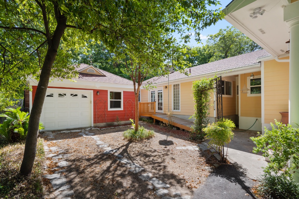 1212 Bentwood Road Austin, TX 78722 - Photo 29 of 32 a view of a house with a small yard plants and large tree