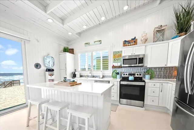 a kitchen with stainless steel appliances kitchen island granite countertop a sink and cabinets
