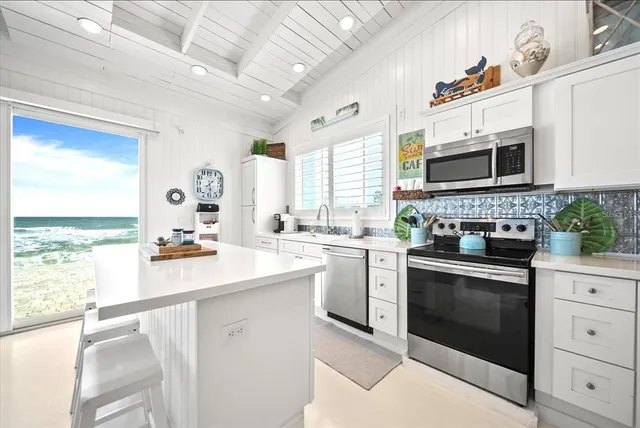 a kitchen with a stove a sink and a microwave